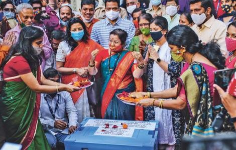 : Government officials pray over a storage box containing Covid-19 vaccines before they leave for various vaccination centres in Mumbai, India, in January this year. India is one of the countries that is calling for patents on Covid-19 vaccines to be waived during the pandemic. DHIRAJ SINGH/BLOOMBERG/GETTY