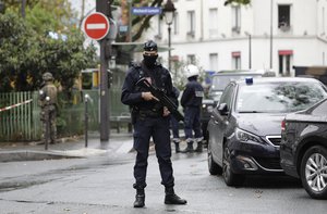 A French riot police officer stands guard after a knife attack near the former offices of satirical newspaper Charlie Hebdo, Friday Sept. 25, 2020 in Paris