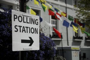 A polling station sign stands displayed in London, Wednesday, May 5, 2021