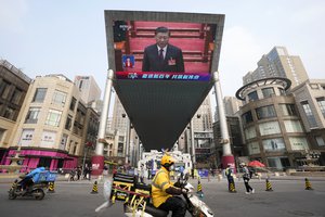 File - Chinese President Xi Jinping is seen on a big screen during a live broadcast of the closing session of the National People's Congress in Beijing on Thursday, March 11, 2021.