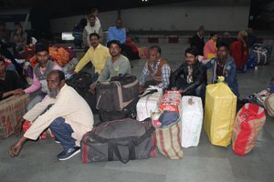 Migrant labourers who were working in Kashmir valley wait for their train at the railway station in Jammu, India, 02 November 2019.