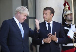 French President Emmanuel Macron and Britain's Prime Minister Boris Johnson gesture after their meeting at the Elysee Palace, Thursday, Aug. 22, 2019 in Paris