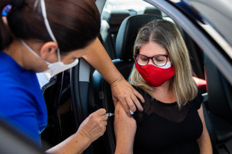 A woman receives the COVID-19 vaccine at a vaccination post in Rio de Janeiro, Brazil. 