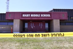 Police tape marks a line outside Rigby Middle School following a shooting there earlier Thursday, May 6, 2021, in Rigby, Idaho.