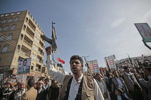 File - A Houthi supporter chant slogans as he attends a rally marking six years of the Saudi-led coalition in Sanaa, Yemen, Friday, March 26, 2021. A fuel tank at an oil facility in Saudi Arabia caught fire after being struck in an attack by Yemen’s Houthi rebels.