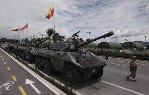 File - Soldiers and army tanks guard toll booths to keep protesters from damaging them, on the outskirts of Bogota, Colombia, Tuesday, May 4, 2021. Colombia’s finance minister resigned on Monday following five days of protests over a tax reform proposal that left at least 17 dead.