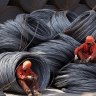 Workers take a break at a stockyard in Shanghai. Demand for Australian iron ore has held up well despite tensions between the two countries.