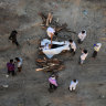 Relatives perform the last rites for the cremation of a man who died after contracting Covid-19 on the banks of the Ganges river in Allahabad, Uttar Pradesh, India.