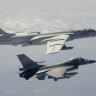 Tension in the skies. A Taiwanese F-16 flies near a Chinese bomber as it passes near Taiwan in 2020. 