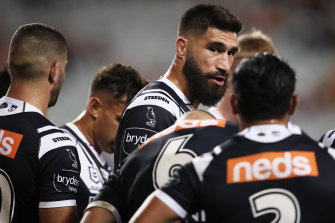 James Tamou gives a pep talk to Tigers teammates behind the line after another Titans try.