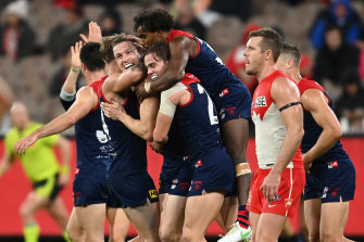 MELBOURNE, AUSTRALIA - MAY 08: Tom McDonald of the Demons is congratulated by team mates after kicking a goal during the round eight AFL match between the Melbourne Demons and the Sydney Swans at Melbourne Cricket Ground on May 08, 2021 in Melbourne, Australia. (Photo by Quinn Rooney/Getty Images)