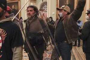 In this Jan. 6, 2021, photo, rioters, including Dominic Pezzola, center with police shield, are confronted by U.S. Capitol Police officers outside the Senate Chamber inside the Capitol, Wednesday, Jan. 6, 2021, in Washington.