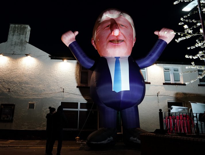 People walk past a giant inflatable representation of Prime Minister Boris Johnson in Hartlepool