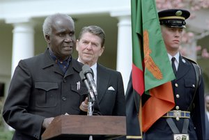 File - The President of Zambia Kenneth David Kaunda addresses the media during a working visit as US President Ronald Reagan looks on, the White House, Washington, March 30, 1983.