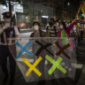 Demonstrators march around the New National Stadium, the main stadium for the Tokyo Olympics, during a protest against the Tokyo Olympics on Sunday, May 09.