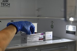 A health worker takes a vial of AstraZeneca Covid-19 from a freezer in Podgorica on April 14, 2021.