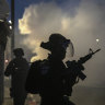 Israeli forces run during clashes with Israeli Arabs in the Israeli mixed city of Lod, Israel.