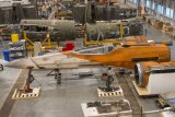 A Star Wars X-Wing Fighter is being constructed and conserved next to a World War II-era air plane in the Mary Baker Engen Restoration Hangar at Steven F Udvar-Hazy Centre in Chantilly, Virginia.