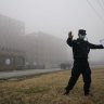 A security person moves journalists away from the Wuhan Institute of Virology after the WHO team arrived in February. 