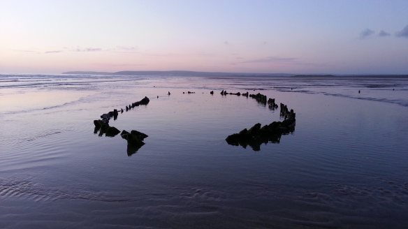 Wrecked boat on Westward Ho! beach, low tide