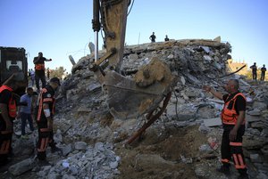 Palestinians rescuers search in the rubble for missing members of the Al-Tanani family, after their house was destroyed by Israeli airstrikes in town of Beit Lahiya, northern Gaza Strip, Thursday, May 13, 2021.