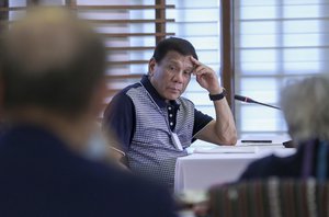 In this handout photo provided by the Malacanang Presidential Photographers Division, Philippine President Rodrigo Duterte listens during an Inter-Agency Task Force for the Management of Emerging Infectious Diseases meeting against the new coronavirus at the Malacanang grounds in Manila, Philippines on Thursday March. 19, 2020.