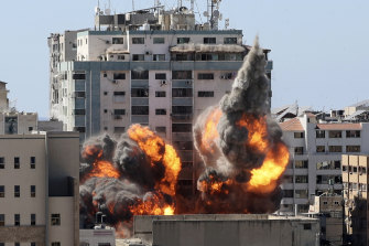 A ball of fire erupts from the media building in Gaza City after an Israeli airstrike.