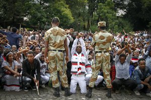 Soldiers try to stop protesters in Bishoftu, during a declared state of emergency, in the Oromia region of Ethiopia