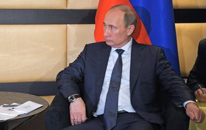 In this photo taken on Wednesday, March 27, 2013, Russian President Vladimir Putin listens to Egyptian President, Mohammed Morsi, unseen, during the BRICS 2013 Summit in Durban, South Africa.