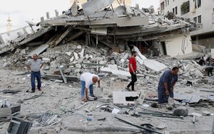 People inspect the rubble of destroyed residential building that was hit by an Israeli airstrike, in Gaza City, Monday, May 17, 2021.