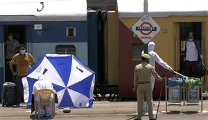 Jammu and Kashmir returnees from Bengaluru de-boarding from a special train at Udhampur railway station during the Coronavirus-driven lockdown in Jammu, India, 12 May 2020.