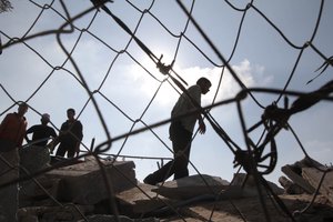 Palestinians inspect the damage to a chicken farm in Rafah town in the southern Gaza Strip on June 6, 2012, following an Israeli air strike, in which two Palestinians were wounded in two strikes according to medical sources.. Photo By Ahmed Deeb/wn