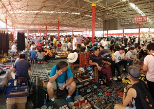 File - People visit Beijing Antique Market. The market also known as The Dirt Market, is Beijing’s biggest and best-known arts, crafts, and antiques market, the Chinese name is "Panjiayuan".