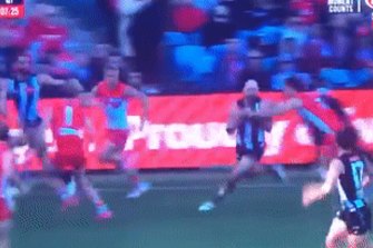 Collingwood star Steele Sidebottom is spun around in a tackle but ‘play on’ is the call.