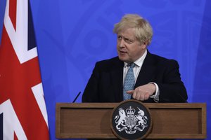 Britain's Prime Minister Boris Johnson gestures as he answers a question from the media at a press conference about the ongoing coronavirus outbreak, in London, Friday, May 14, 2021