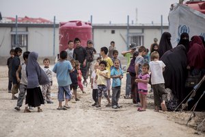 Women and children gather in front their tents at al-Hol camp that houses some 60,000 refugees, including families and supporters of the Islamic State group, many of them foreign nationals, in Hasakeh province, Syria, Saturday, May 1, 2021.