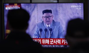 People wearing face masks watch a TV screen, showing North Korean leader Kim Jong Un, during a news program reporting about the ceremony to mark the 75th founding anniversary of the North Korea's ruling Workers' party, at the Seoul Railway Station in Seoul, South Korea, Saturday, Oct. 10, 2020.