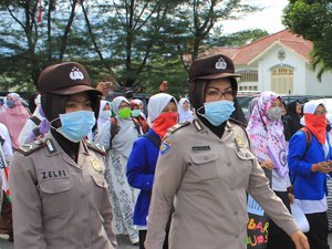 Female police with face mask and hijabs during protests in Padang, Indonesia