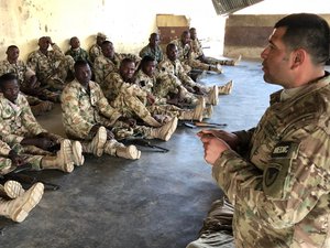 File - U.S. Army Soldiers share tactics and training with 200 Nigerian Army Soldiers at a remote military compound in Nigeria. The seven-weeks of training include reacting to an ambush, securing an objective and operational planning.