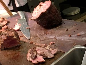 A large meat being carved at a station in a restaurant. Taken on July 2017.