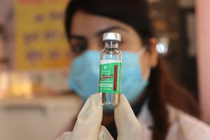 A medic inoculates the dose of the second vaccine shot of the COVID-19 vaccine to a beneficiary,at health center in Jammu, India, 15 May 2021.