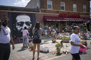 People walk through George Floyd Square after shots were fired on the one year anniversary of George Floyd's death on Tuesday, May 25, 2021, in Minneapolis