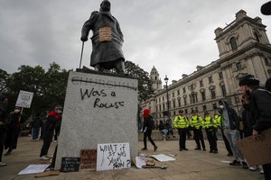 File - Protesters and police gather around Winston Churchill statue in Parliament Square during the Black Lives Matter protest rally in London, Sunday, June 7, 2020, in response to the recent killing of George Floyd by police officers in Minneapolis, USA, that has led to protests in many countries and across the US.