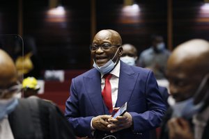 Former South African President Jacob Zuma, smiles, in the High Court in Pietermaritzburg, South Africa, Wednesday May 26, 2021, at the start of his corruption trial