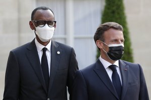 French President Emmanuel Macron, right, welcomes Rwanda President Paul Kagame, left, for a dinner with leaders of African states, at the Elysee Palace, in Paris, Monday, May 17, 2021