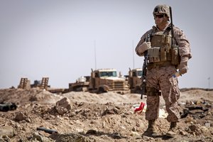 U.S. Marine Corps Staff Sgt. Marcos E. Baeza, an equipment advisor with the 215th Corps Engineer Advisor Team, alongside engineers with 2nd Combat Engineer Battalion, Regimental Combat Team 7 (RCT) 7, observes his Afghan National Army engineer counterparts during a clearing operation near Camp Shorabak, Helmand Province, Afghanistan, March 16, 2013.  The advisor team was there to mentor and advise the ANA heavy equipment operators on the proper use of their equipment. (U.S. Marine Corps photo by Staff Sgt. Ezekiel R. Kitandwe/Released)