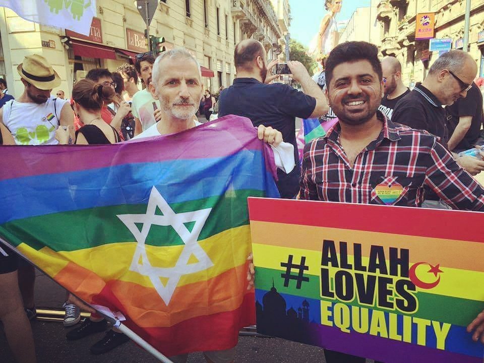 progressivejudaism:
“[Image description: 2 men are standing amongst other people in what seems like an LGBT+ Pride event. The gentleman on the left, who looks like he is in his 60s and has gray hair and a beard, is holding a large Pride rainbow flag...