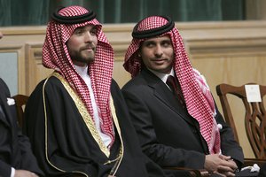 In this Nov. 28, 2006, file photo, Prince Hamzah Bin Al-Hussein, right, and Prince Hashem Bin Al-Hussein, left, half brothers of King Abdullah II of Jordan, attend the opening of the parliament in Amman, Jordan.