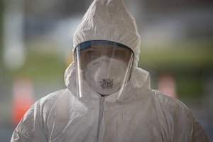 A medical technician pauses between patients at a COVID-19 Community-Based Testing Site at the PNC Bank Arts Center in Holmdel, N.J., March 23, 2020