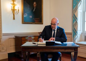 Greek Foreign Minister Nikos Dendias signs Secretary Pompeo's guestbook before their meeting